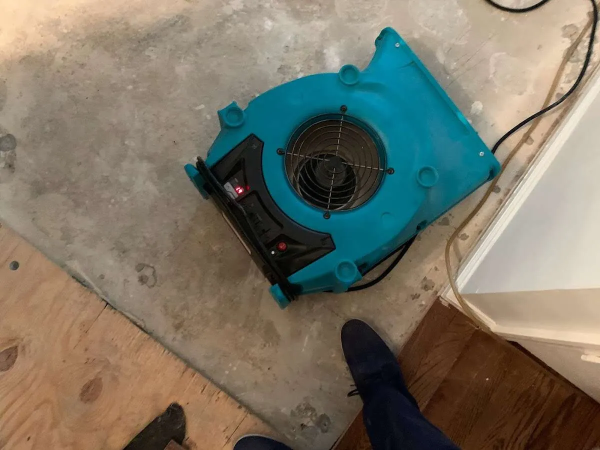 Air mover drying subfloor during Commercial Water Damage Restoration in Umatilla